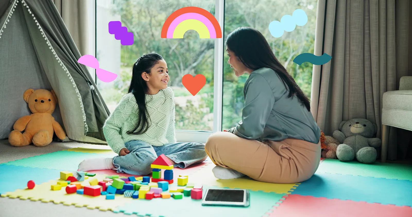 A clinician and child playing with blocks on a play mat at home