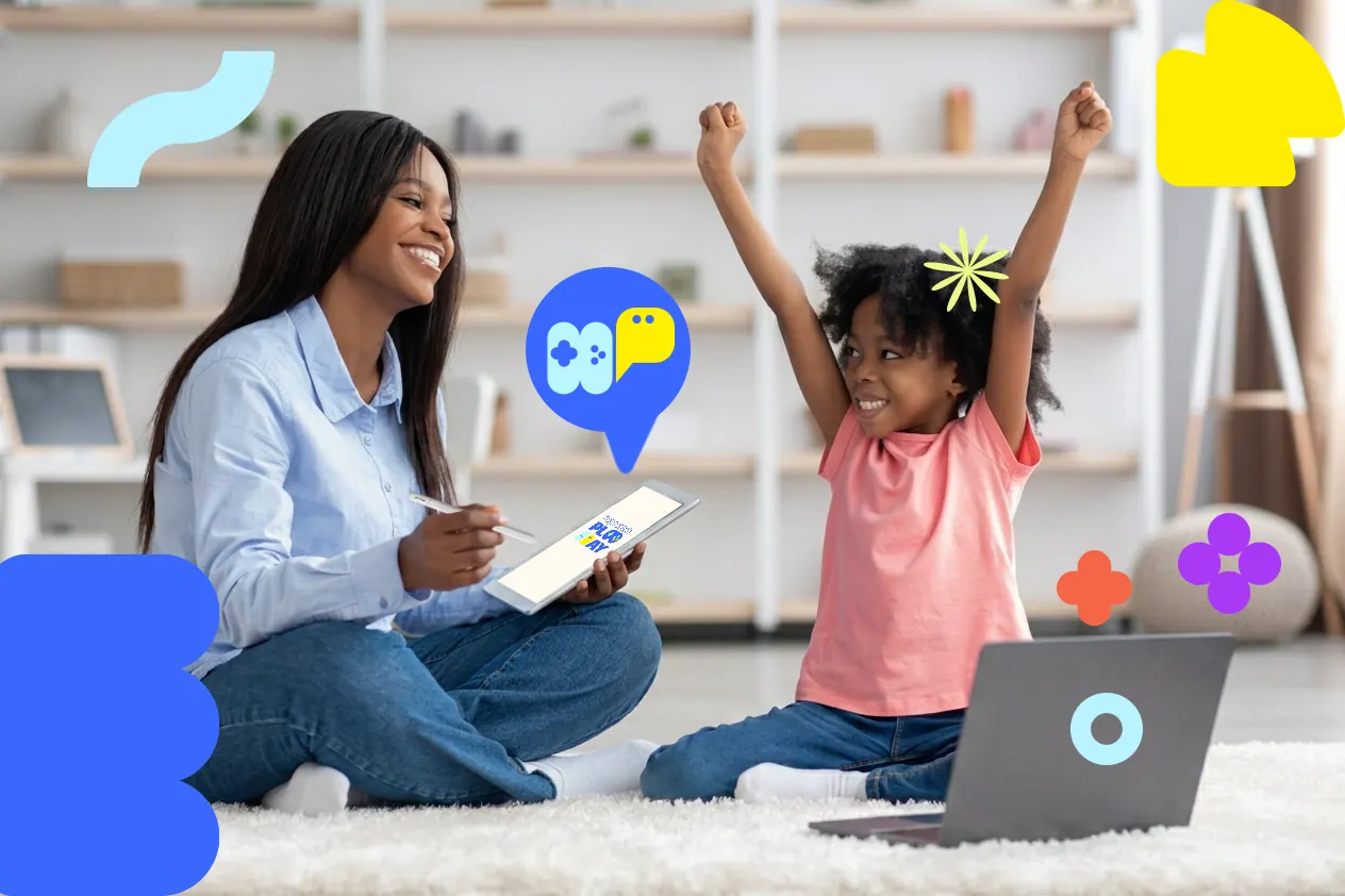 A therapist and child celebrating during a Hopscotch Play session